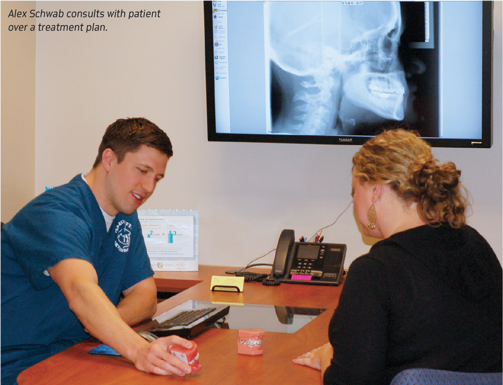 Alex Schwab consults with a patient over a treatment plan